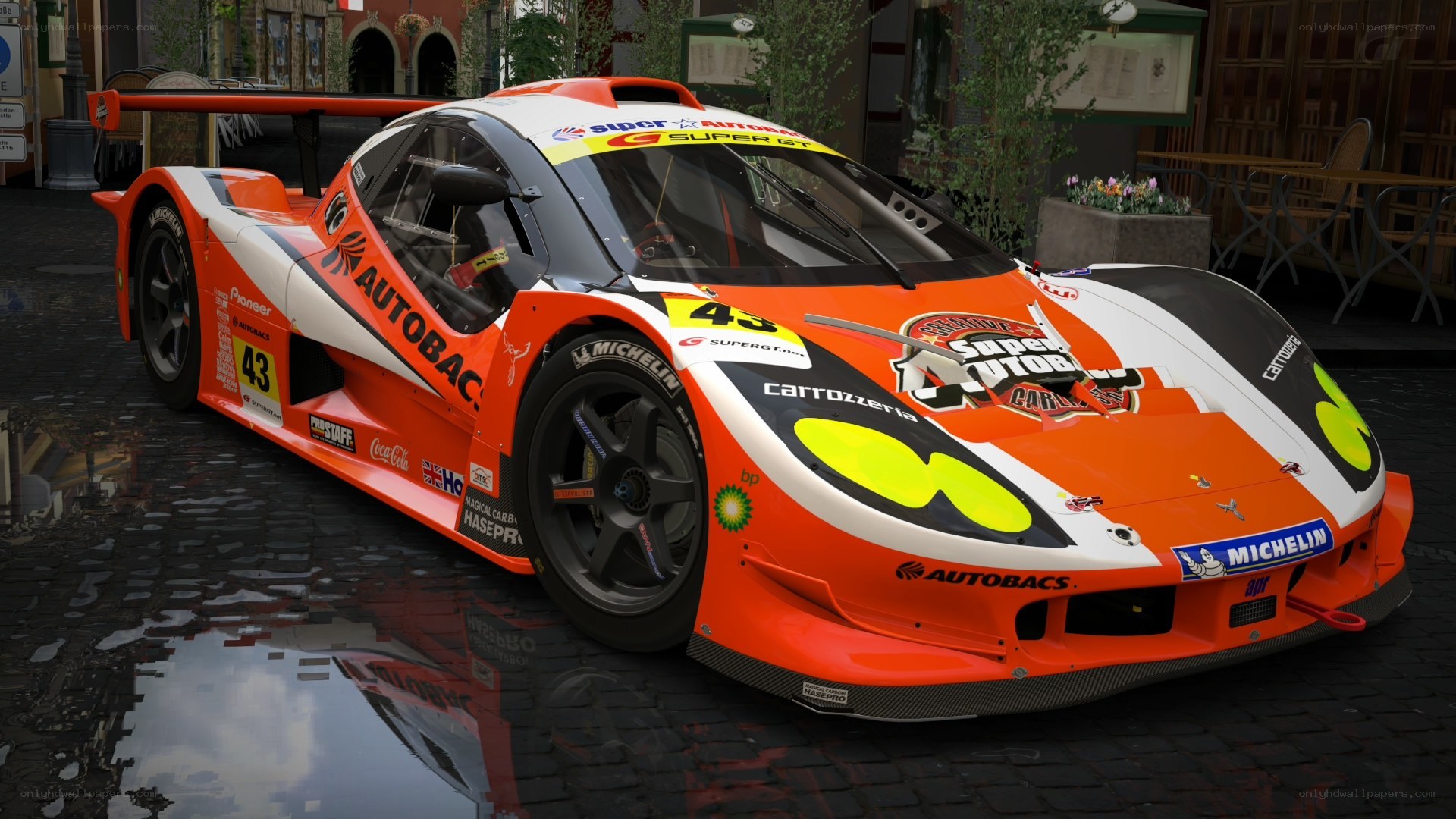 orange race car on cobblestones