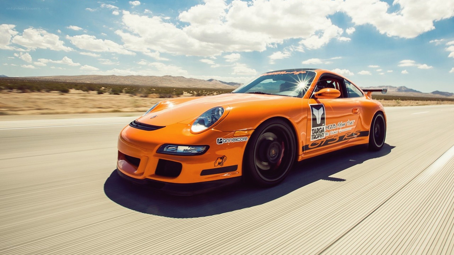 orange race car on desert road
