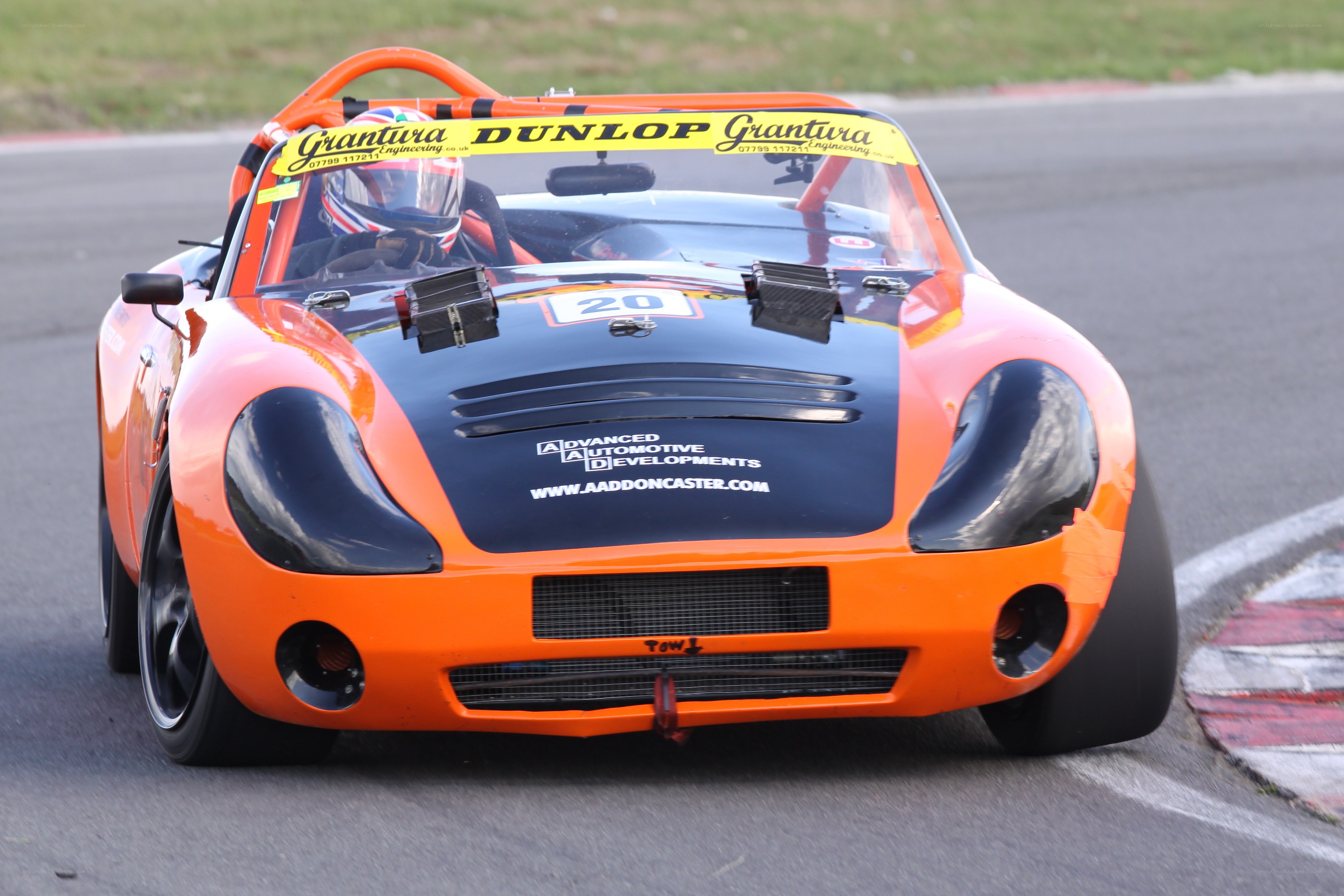 orange race car on track