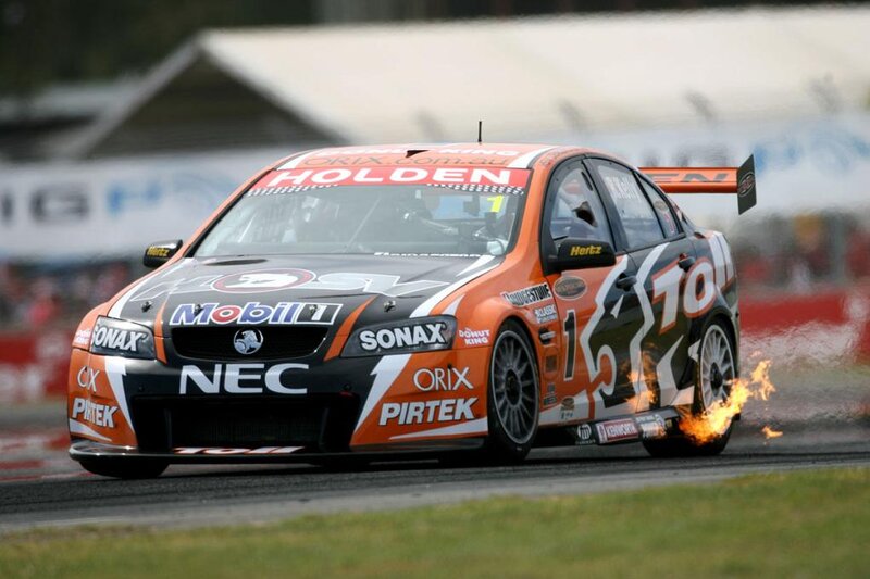 Orange Race Car on Track — Dramatic