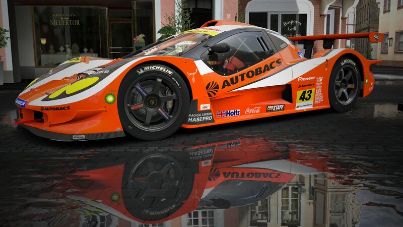 orange race car on wet street