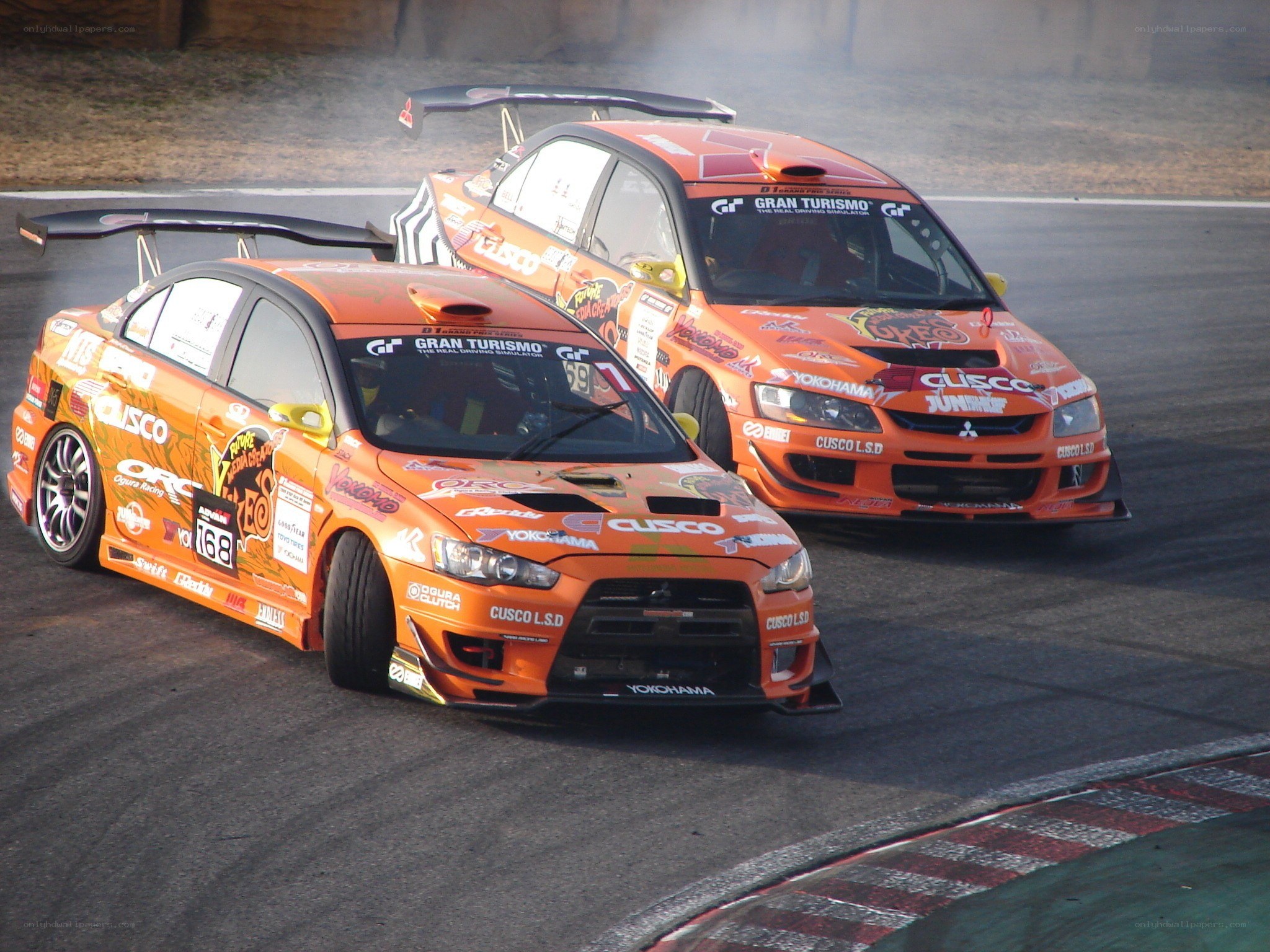 Orange race cars drifting