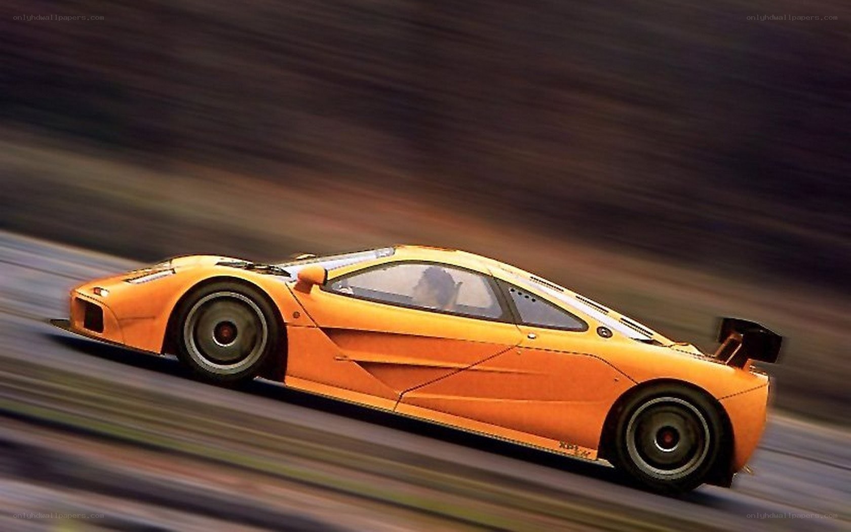orange racing car in motion