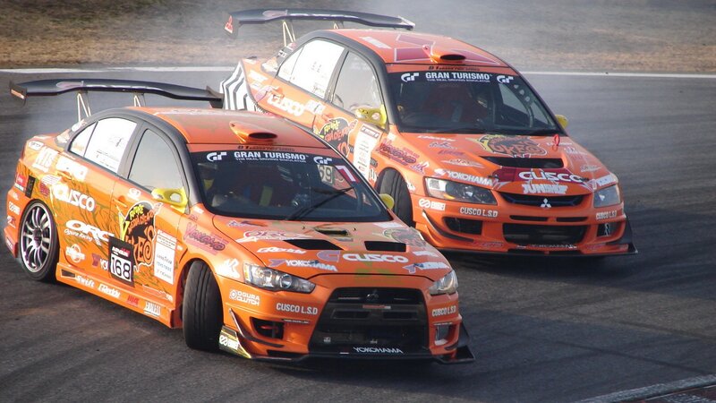 Orange racing cars on track