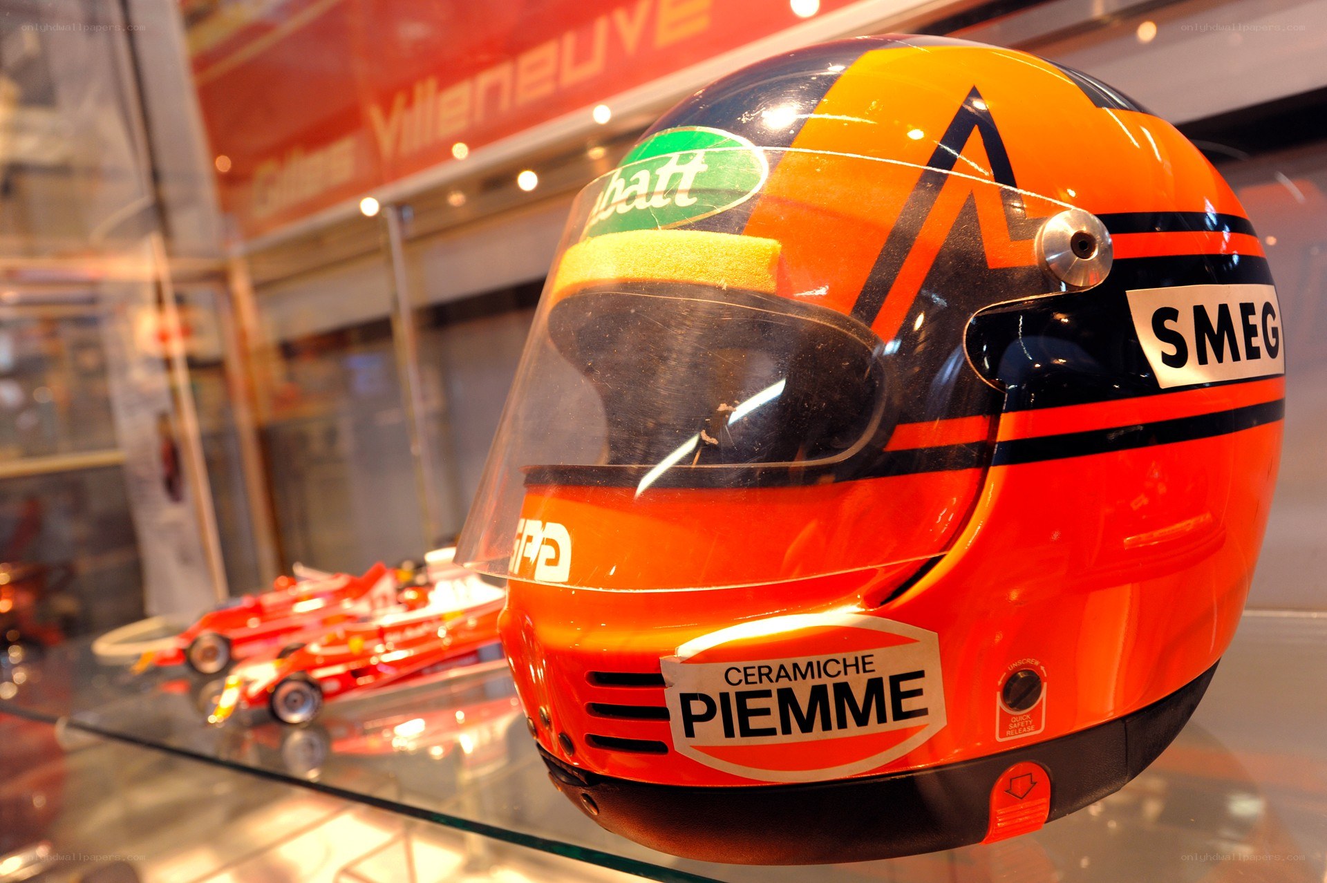 Orange racing helmet on display