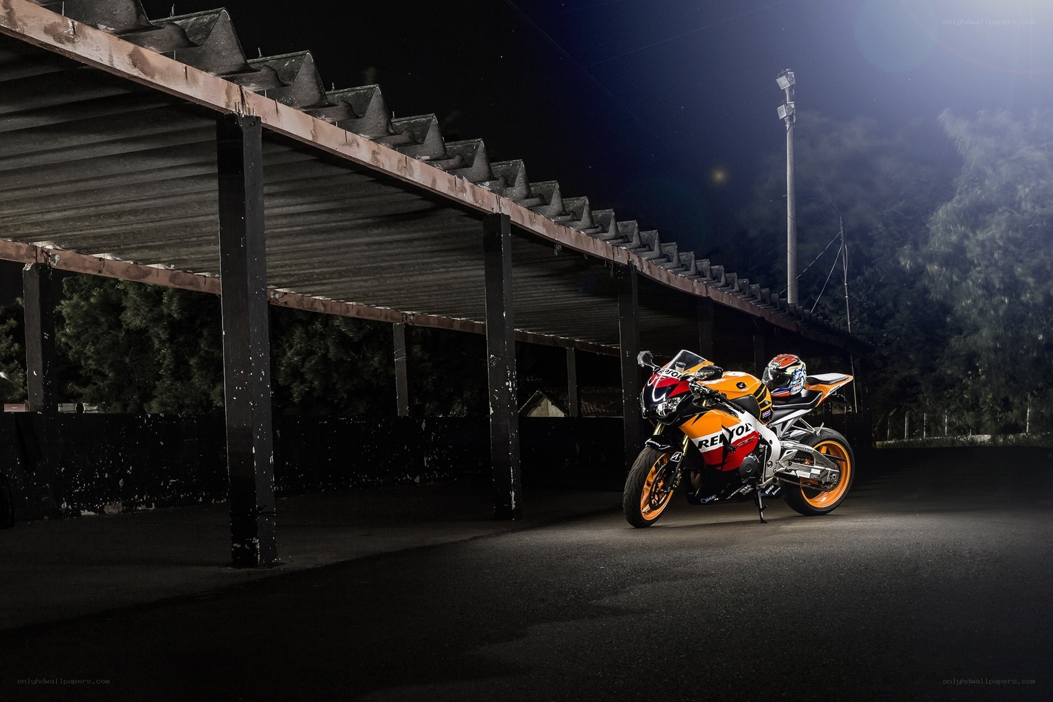 Orange racing motorcycle at night