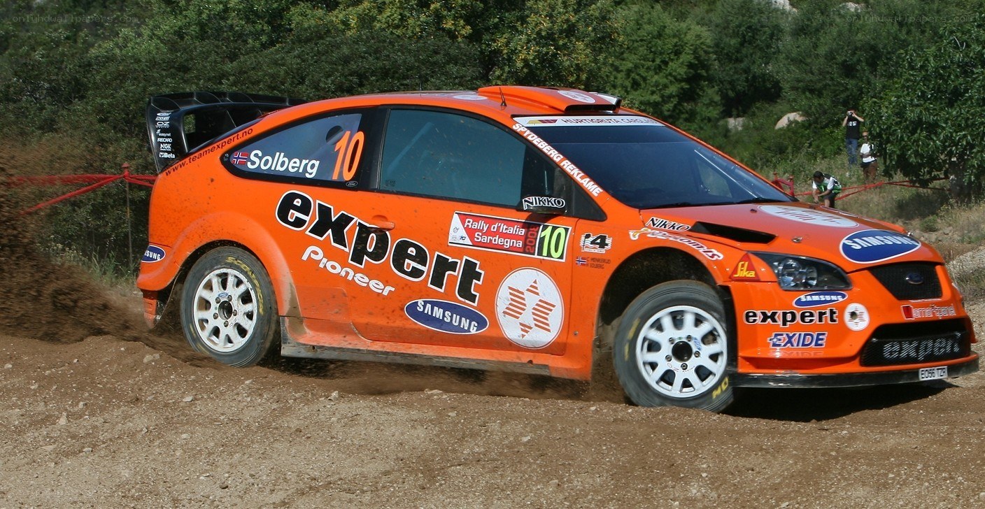Orange rally car in action