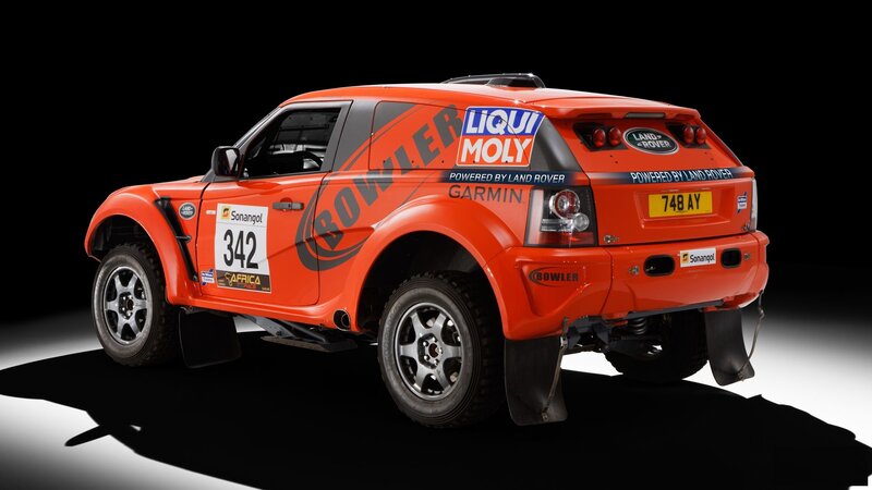 Orange rally car with sponsor logos