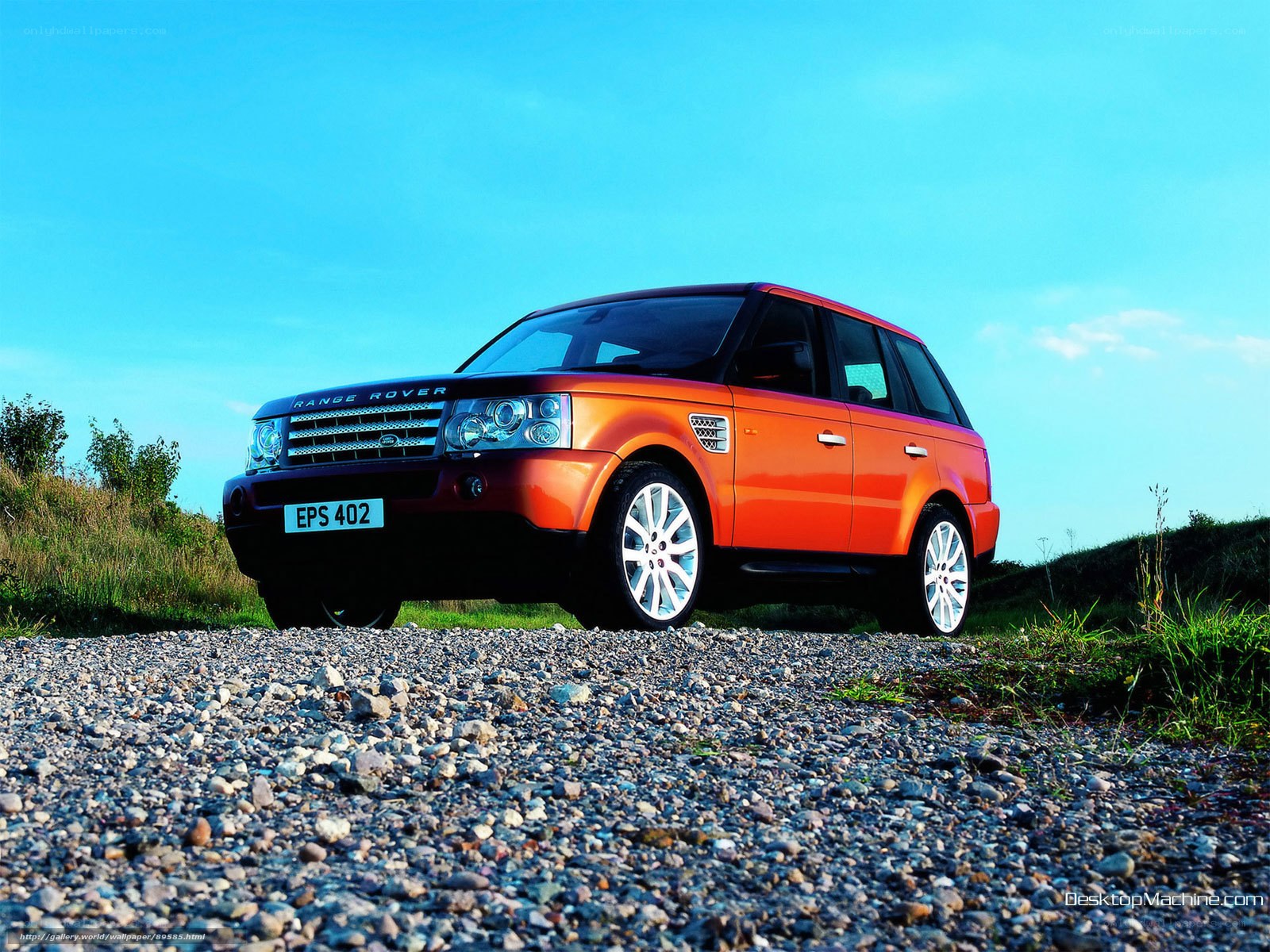 Orange Range Rover on gravel