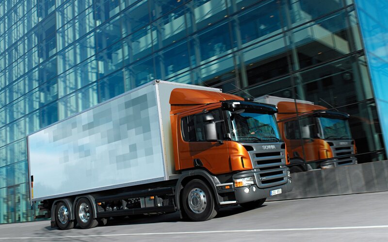 Orange Scania truck in city