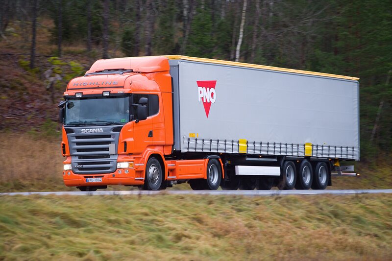 orange Scania truck on road