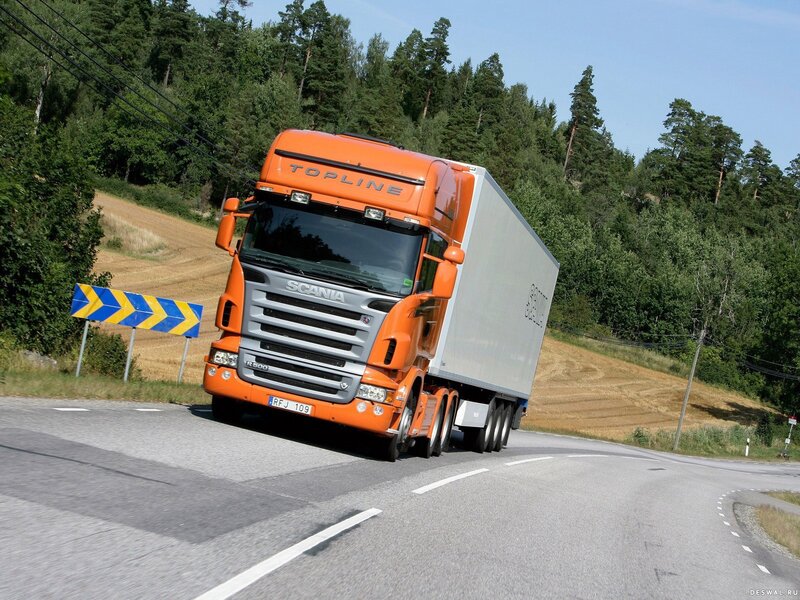 orange Scania truck on road