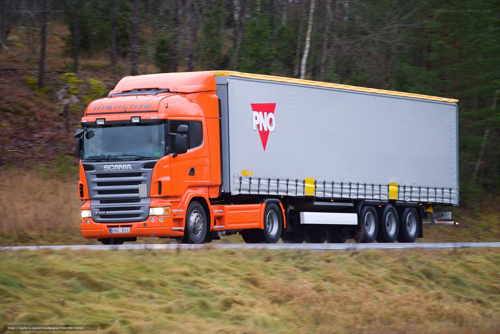 orange Scania truck on road