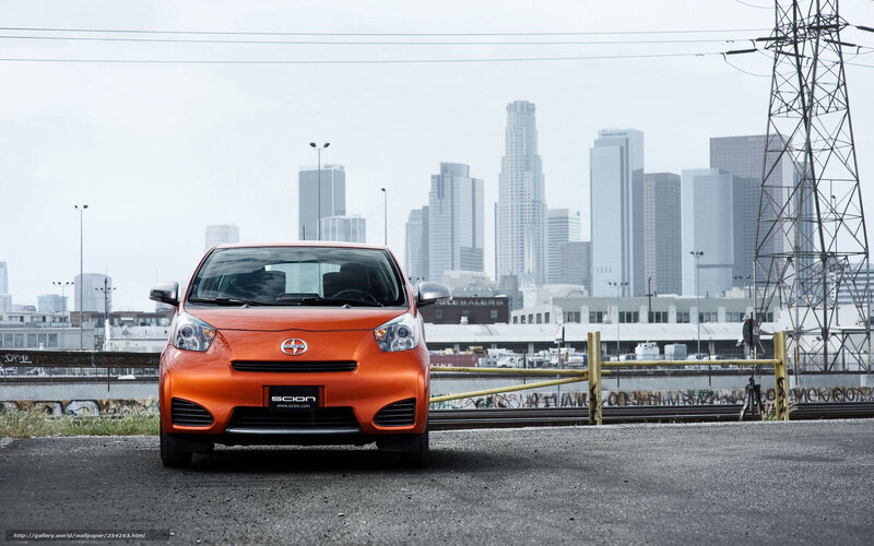 Orange Scion iQ in urban setting