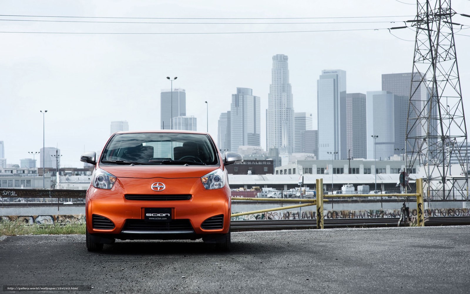 Orange Scion iQ in urban setting