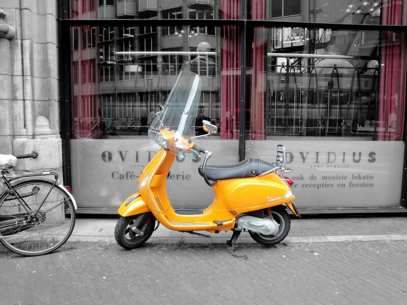 Orange Scooter on Sidewalk