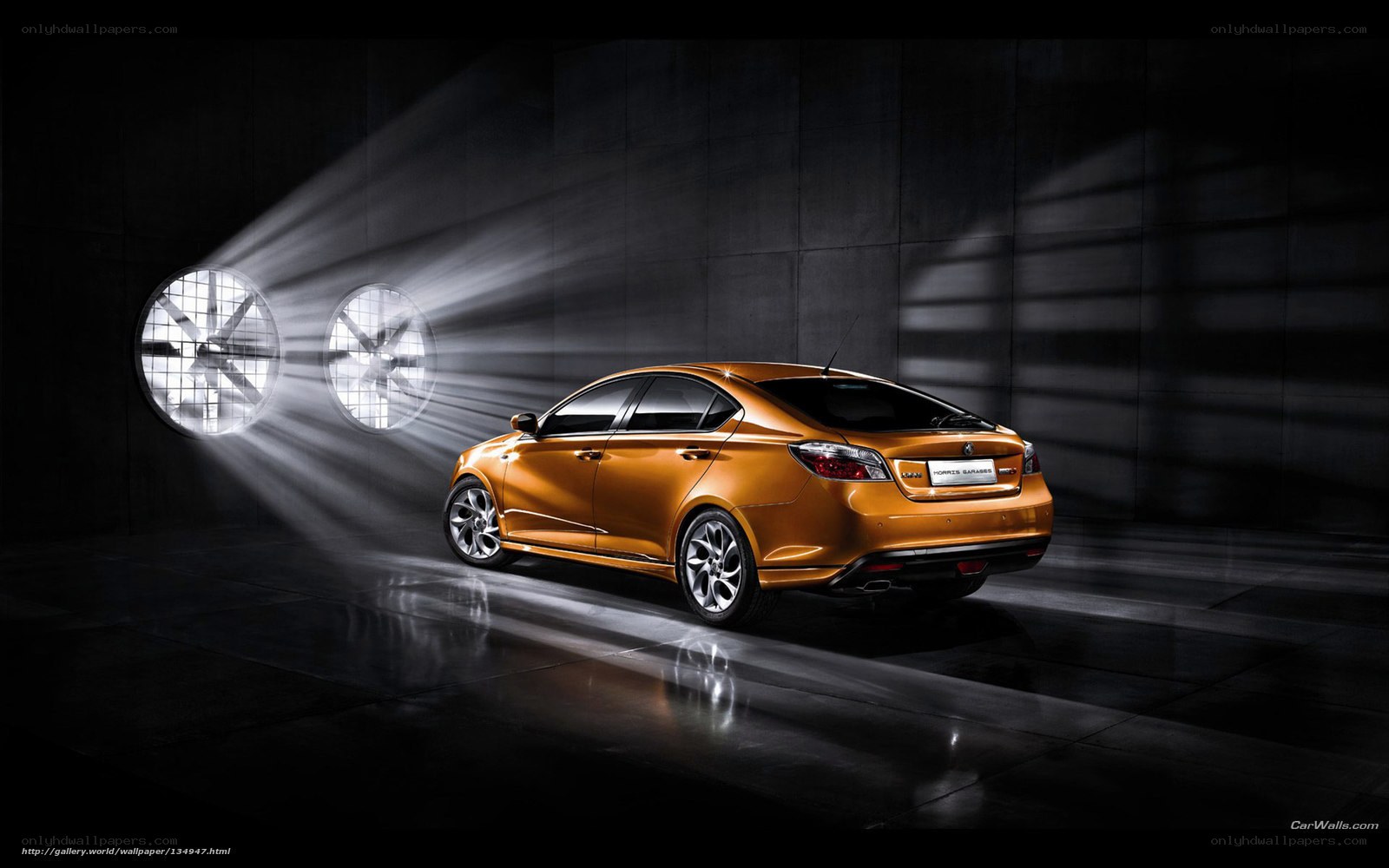 Orange sedan in dark garage