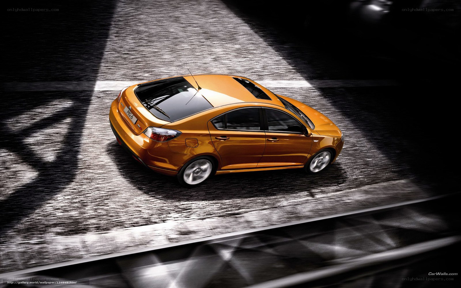 Orange sedan in motion