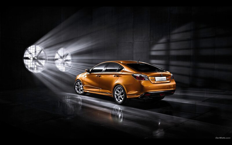 Orange sedan in studio lighting