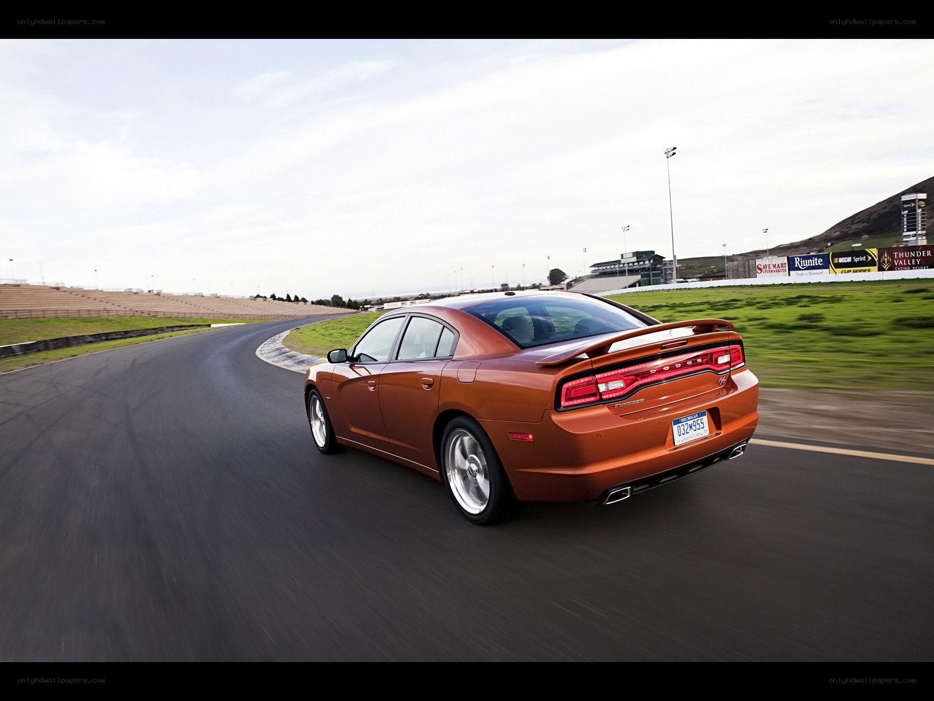 Orange sedan on racetrack