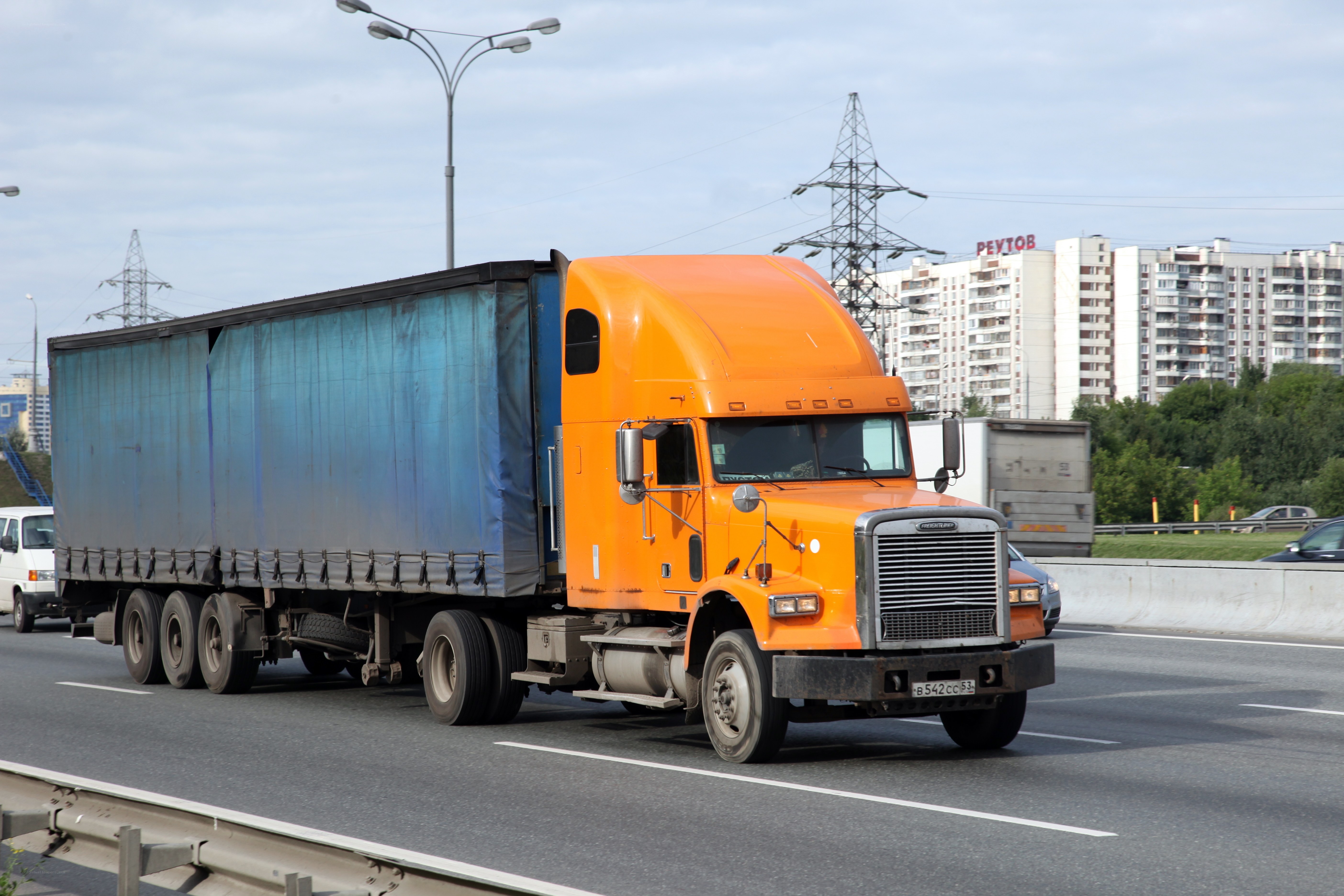 Orange semi-truck on highway