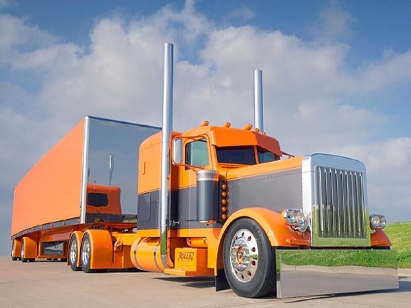orange semi-truck with trailer
