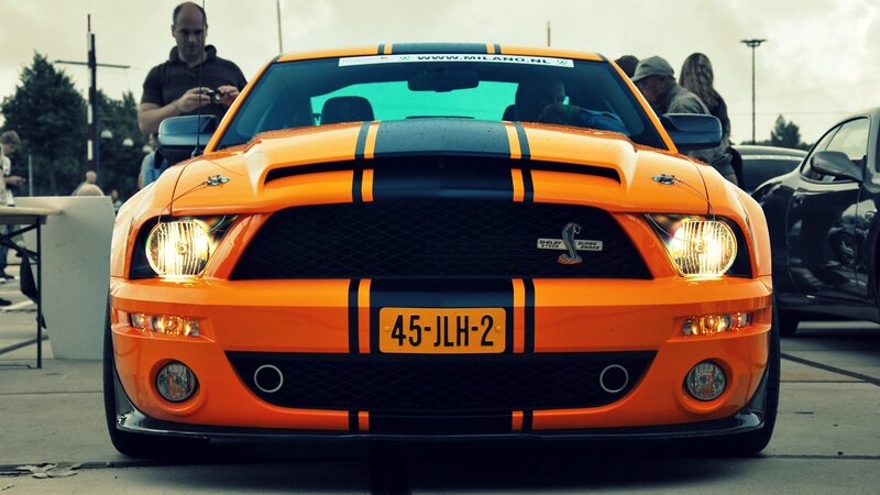 orange shelby mustang at car show