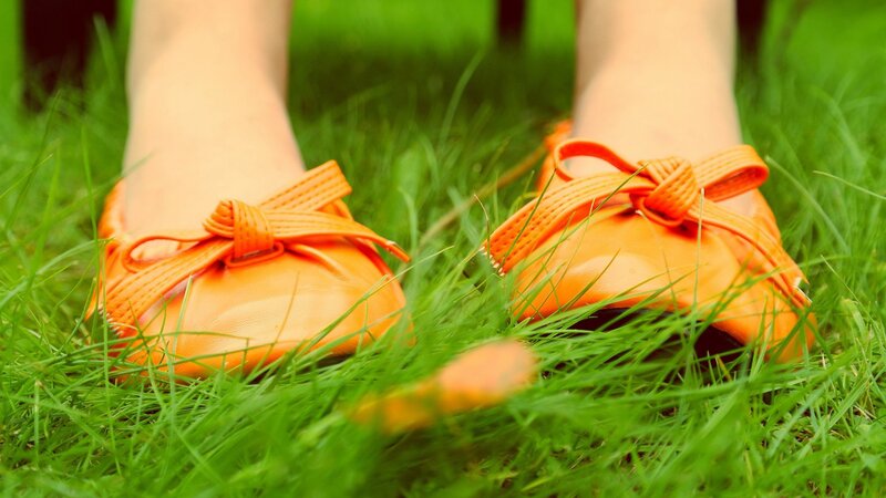 orange shoes on green grass