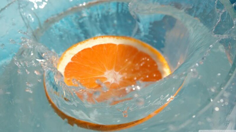 Orange Slice in Water — Dynamic, Photograph