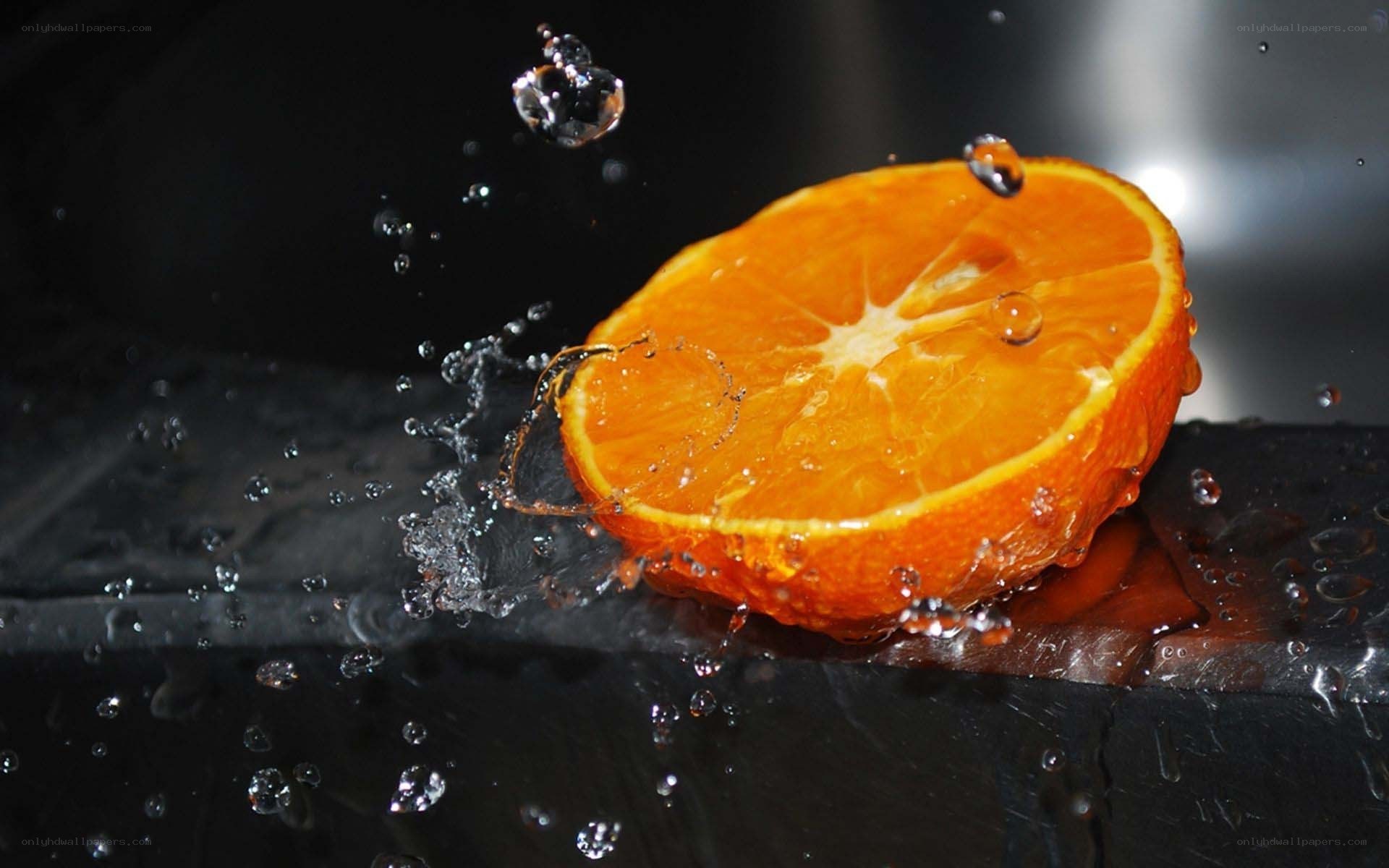 orange slice splashing in water