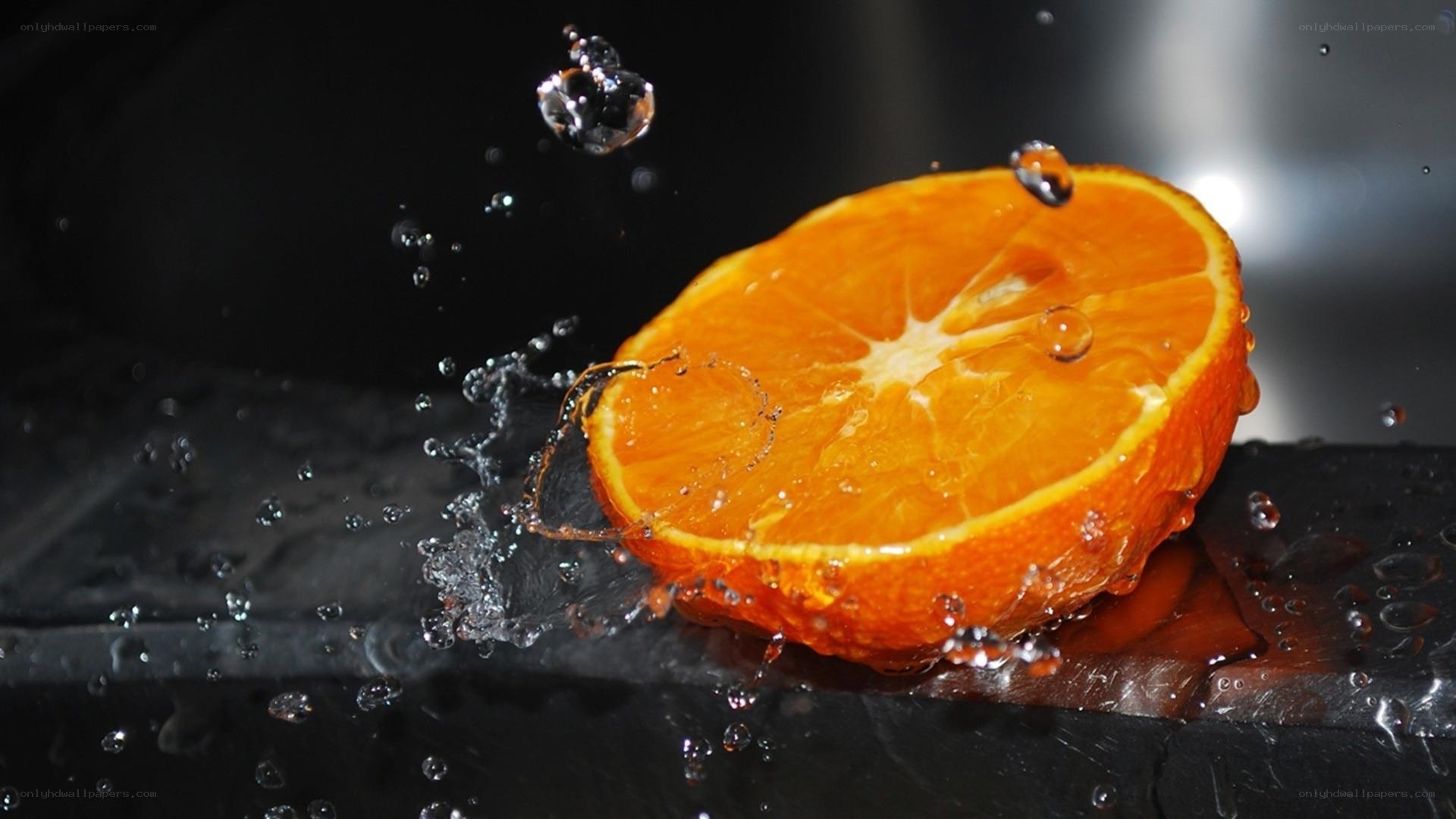 Orange slice splashing in water