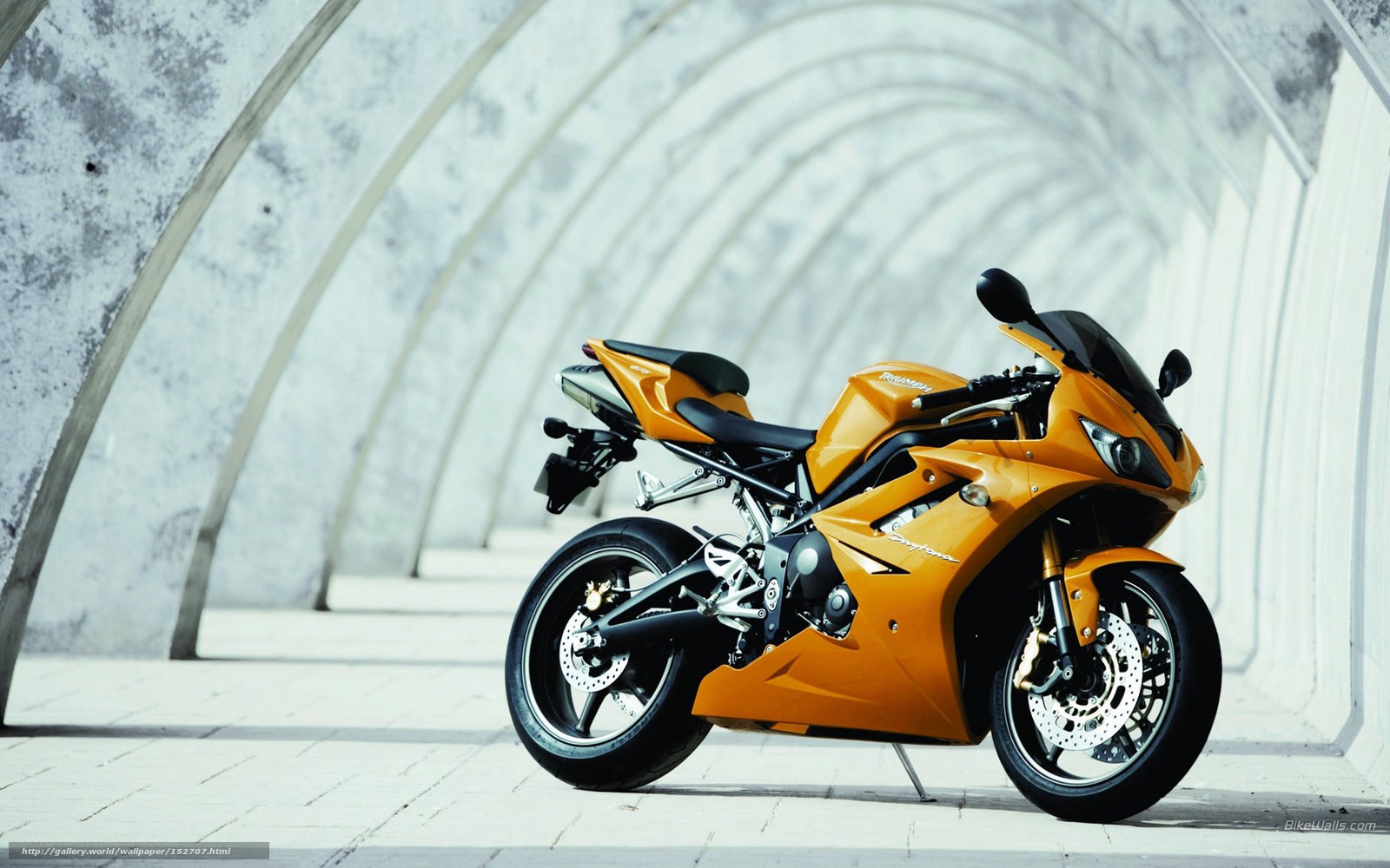 orange sport motorcycle in tunnel