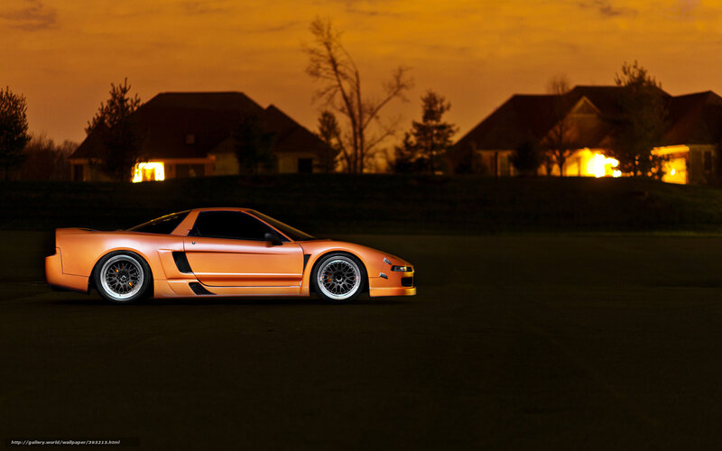 Orange sports car at dusk