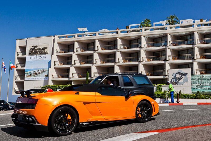 Orange sports car at hotel