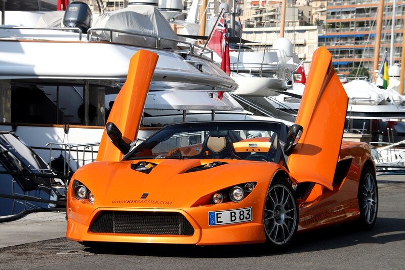 Orange sports car at marina