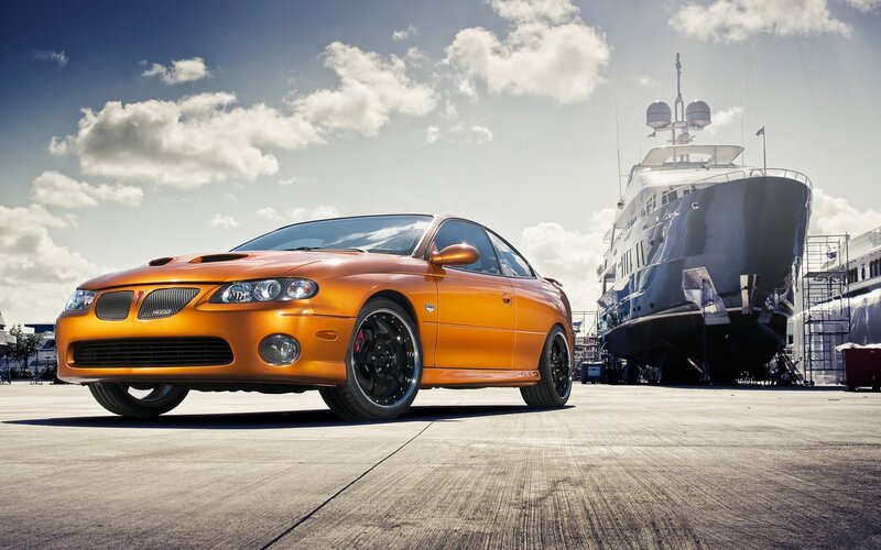 Orange sports car at marina