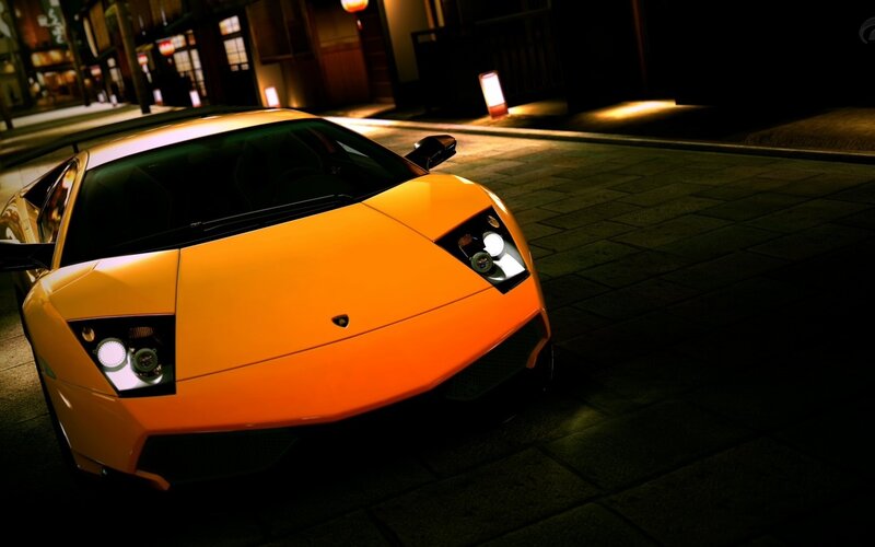 orange sports car at night