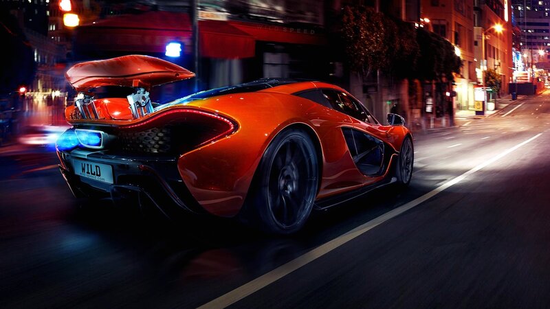 Orange sports car at night
