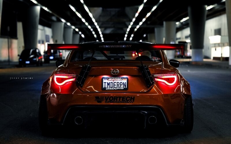 Orange sports car at night