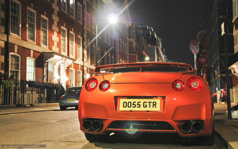 Orange sports car at night