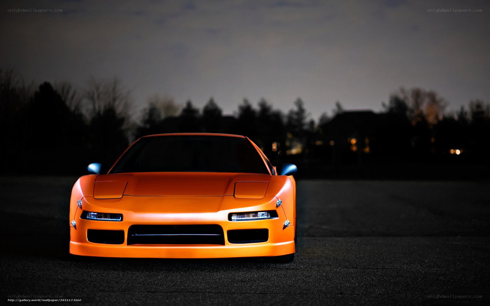orange sports car at night