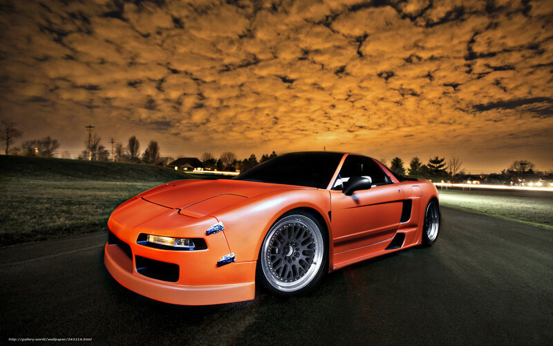 Orange sports car at night