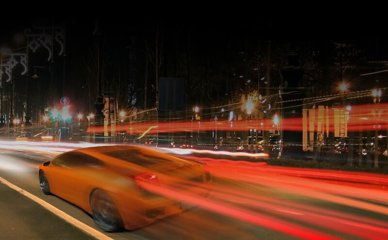 Orange sports car at night