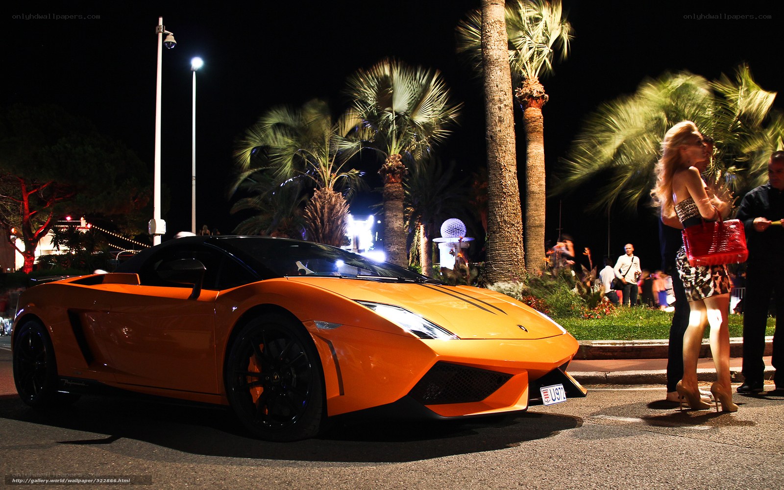 Orange sports car at night event