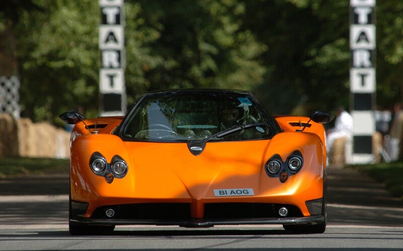 Orange sports car at start line