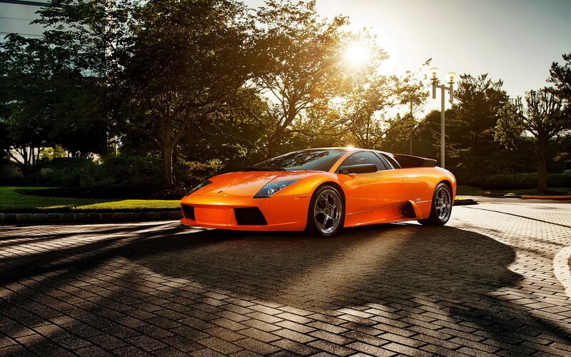 orange sports car at sunset