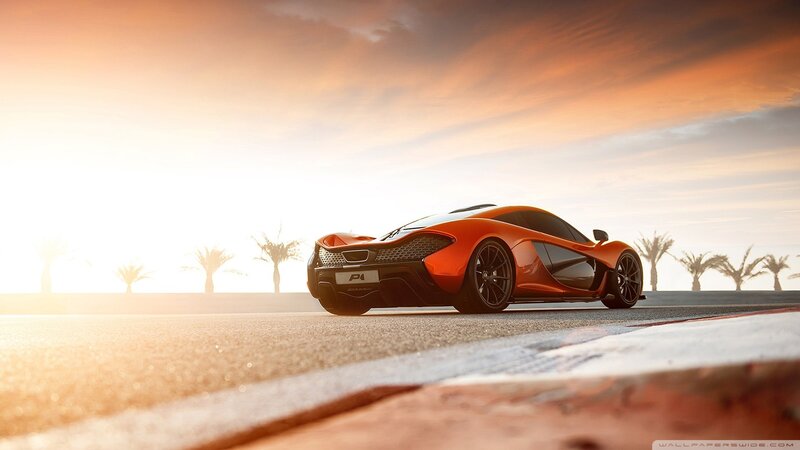 orange sports car at sunset