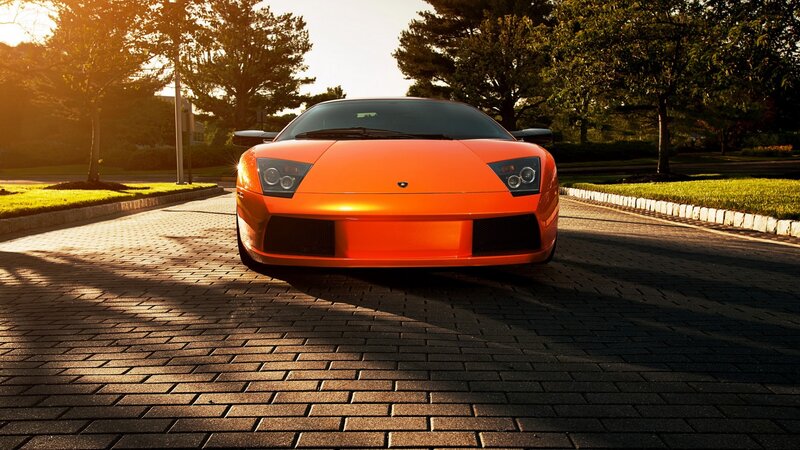 orange sports car at sunset