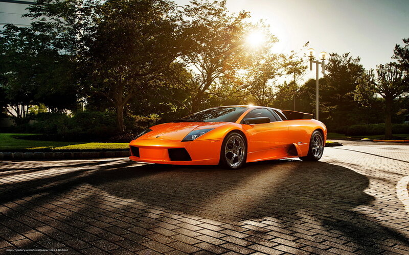 Orange sports car at sunset