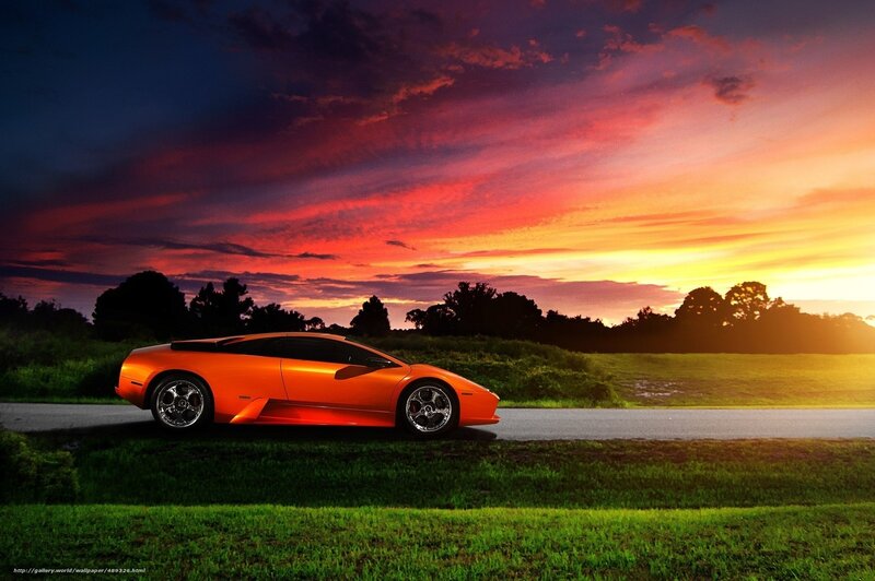Orange sports car at sunset